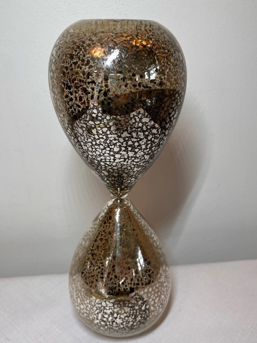 Metallic Mercury Glass Hourglass Sculpture. Black sand